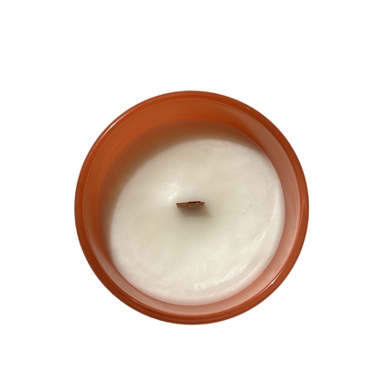 White candle in a terracotta holder on a white background
