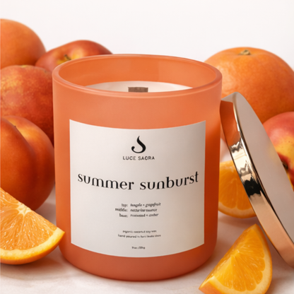 Candle labeled 'summer sunburst' by Luce Sada with peaches and oranges on a white background