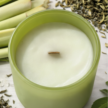 Green 'zen' candle with decorative elements on a white background